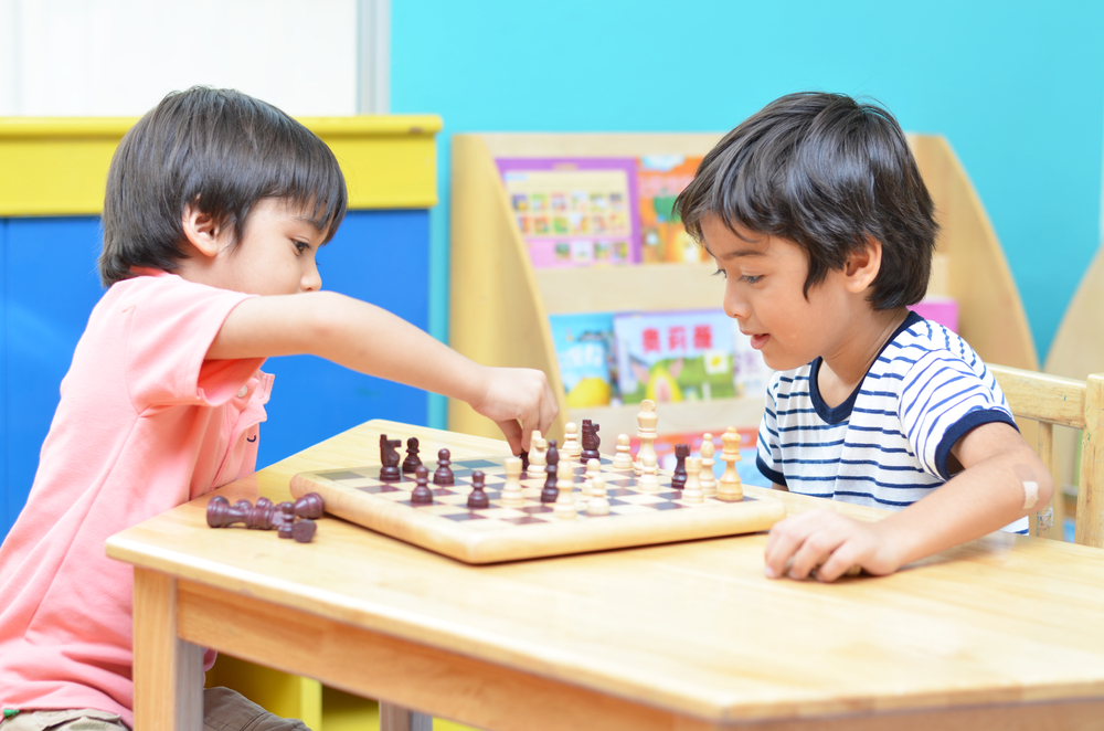 Image of two kids playing Chess.