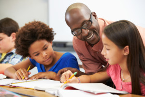 Teacher helping students learn to read