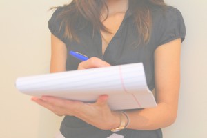 Female teacher writing notes