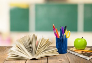 Image of a desk with a notepad and pen