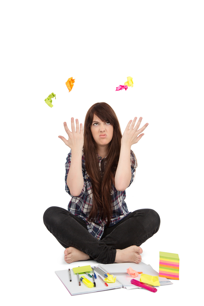 Frustrated teen throwing post-it notes