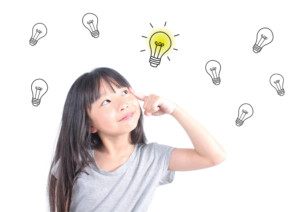 Girl thinking with drawn lightbulbs
