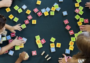 Students playing with letter blocks