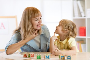 Teacher and child working on letter sounds