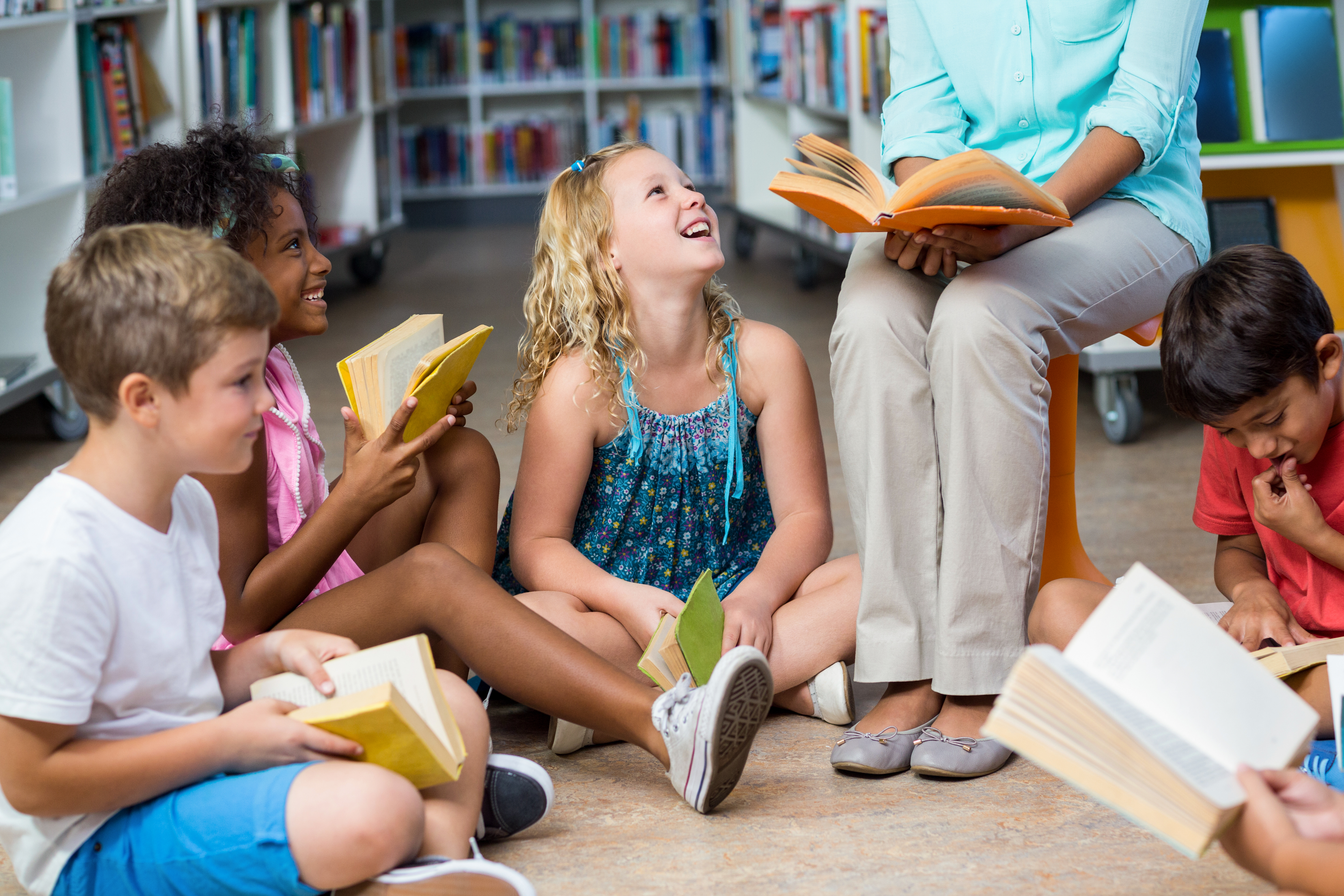 Teacher and students reading in a circle