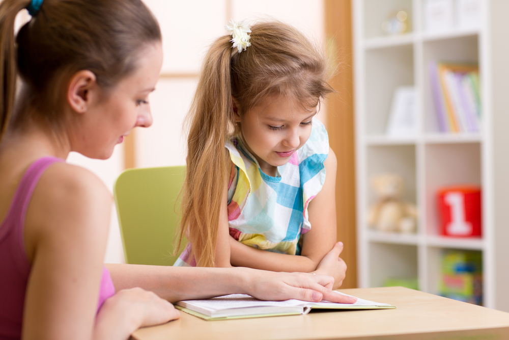 Image of a teacher and a student reading