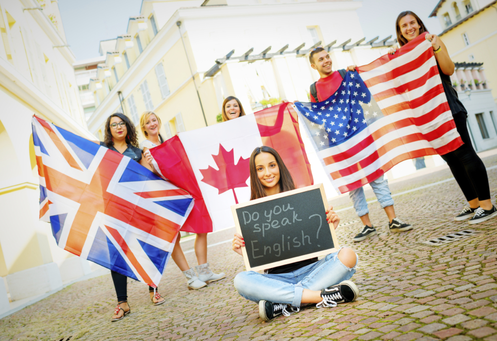 Image of College students learning English with flags and blackboard, outdoors.