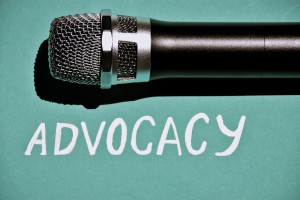 The word Advocacy under the image of a microphone