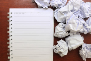 image of a notebook and crumpled papers around it